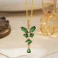 Macro view of a gold-plated necklace featuring an emerald green butterfly pendant. - Hollow Butterfly Style (80490) / Pendant Only (With Stainless Steel Chain) / Gold Tone (Emerald Green Zirconia)