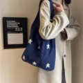Navy blue knitted tote bag featuring white star patterns and cable-knit textures. - Star Pattern / Dark Blue