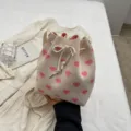 Minimalist beige knit bucket bag featuring pink heart patterns and a drawstring closure - Pink Heart