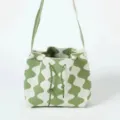 Stylish green and white wavy pattern knitted bucket bag featuring a drawstring closure - Wave Green