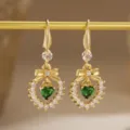 Close-up of vintage gold plated earrings with a heart-shaped green zircon stone - Bowknot Heart Style (80493) / Earrings / Gold Tone (Emerald Green Zirconia)