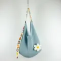 Light blue crochet shoulder bag with colorful strap and cute flower charm for women. - Large Flower Pattern / Light Blue