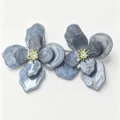 Macro view of elegant grey-blue marble flower stud earrings with gold crystal centers. - Gold Flower Stud Earrings (E5538) / Blue
