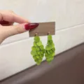 Green layered acetate sequin tassel earrings displayed on a wooden card variant - Stud Style (E4785) / Light Green