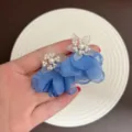 Handheld view of elegant blue fabric petal earrings with white pearls for summer - Artificial Pearl Chiffon Flower Earring (E5432) / Dark Blue
