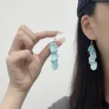 Elegant light blue acetate disc tassel earrings shown being worn by an Asian model - Multi-layer Round Acetate Tassel Style (E4857) / Light Blue