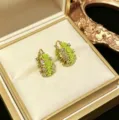 Elegant gold-plated hoop earrings featuring light green rose flowers and small crystals. - Rose Hoop Earring (E5410) / Green
