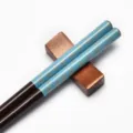 Traditional Japanese wooden chopsticks with light blue sakura pattern and dark wood rest - Silver Petals on Blue Background (Style 09)