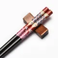 Japanese wooden chopsticks with decorative fish print and pointed tips for sushi. - Red Fish on Black Background (Style 01)