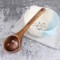 Long-handled wooden soup ladle with deep brown natural grain finish for home kitchen use - Aged Lacquer Duck-billed Spoon