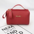 Portable red pebble texture makeup bag with sturdy top handle and gold KUOY logo - Burgundy