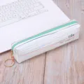 Minimalist striped PU pencil pouch with green zipper and gold keyring on a white laptop - Cyan Striped