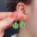 Elegant gold tulip hoop earrings with green stones and sparkling white rhinestones - Tulip Cat Eye Stone Hoop Style (E2373 Gold Green) / E2373 Gold Green