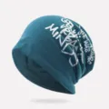 Teal slouchy beanie with silver GREAT MINDS graffiti print for unisex hip-hop style. - One Size / Unlined / Ink Blue