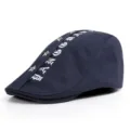 Navy blue cotton flat cap with gothic letter embroidery and silver star studs. - One Size / Letter Style / Dark Blue