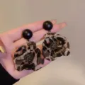 Detailed close-up of vintage leopard print flower earrings featuring a black stud - Double Layer Flower Leopard Earrings (E4693) / Gold (E4693)