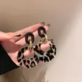 Detail view of vintage leopard print hoop earrings featuring black flocked tops and gold links - Long Oval Leopard Style (E4364) / Gold (E4364)