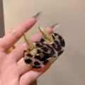 Close-up of vintage leopard print resin stud earrings with textured gold accents - French Retro Semi-Circle Leopard Style (E5070) / Gold (E5070)