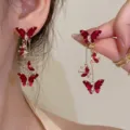 Detailed macro view of heavy industry Ankara red butterfly tassel earrings with crystals. - Butterfly Long Tassel Style (E4089 Gold Red)