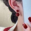 Elegant glossy Ankara red double-sided bead stud earrings worn by an Asian model - E3796 Gold Red Pearl (Double Bead Style)