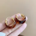 Close-up of U-shaped brown resin hoop earrings featuring polished gold-plated metal accents - French Retro U-Shaped Ear Buckle (E5065) / Gold (E5065)