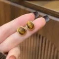 Close-up of vintage brown geometric square stud earrings in a gold-tone setting. - Square Cat Eye Stone Style (E5064) / Golden Coffee