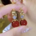 Detailed view of elegant French vintage red pearl earrings with sparkling zircon accents - Geometric Hollow Spherical Style (E4304)