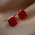 Elegant Ankora red square stud earrings with gold-toned edges on soft fabric background - Square Gold Edge Style (E2533)