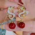 Vintage gold dragon earrings with deep red beads and sparkling rhinestones for women. - Dragon Pendant Style (E3788)