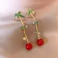 Elegant vintage bamboo dangle earrings featuring green enamel leaves and vibrant red beads - Bamboo Joint Tassel Style (E3959)