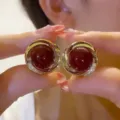 Elegant French vintage gold stud earrings featuring a dark red resin stone and rhinestones - Spiral Swirl Style (E4168)