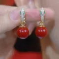 Elegant snake head drop earrings with a vibrant red round bead and green stone eyes - Green-Eyed Snake Head Red Round Bead Style (E4567)