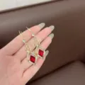 Vintage gold-toned dangle earrings featuring red rhombus crystals and shimmering pavé. - Rhombus Crystal Tassel Style (E1403)