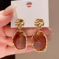 Elegant gold textured stud earrings with amber resin drop pendants for SKU display - Hammered Amber Resin Style (E3983 Gold Red)
