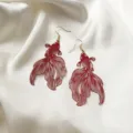 Elegant red koi fish filigree drop earrings with gold hooks on silk background for festive look - Hollow Goldfish Style (E4150) / Ancorra Red