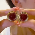 Vintage Ankara red round stud earrings with golden swirl frame and shimmering crystals - Spiral Vortex Rhinestone Style (E4168) / Red & Gold