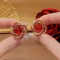 Elegant retro gold earrings featuring vibrant red crystals and sparkling rhinestones - Large Multi-faceted Red Crystal Style (E3098) / Ancorra Red