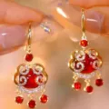 Elegant vintage red Pixiu drop earrings with gold-tone finish and sparkling crystal accents. - Ruyi Lock Rhinestone Tassel Style (E3181) / Ancorra Red