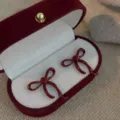 Elegant dark red bow-knot stud earrings presented in a luxury velvet jewelry box - 3D Bow Stud Earrings (E4346) / Red