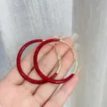 Chic Ankara red and gold hoop earrings held in hand for size reference - Ankara Red Color-Block Hoop Style (E4359) / Burgundy