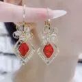 Elegant red faceted crystal flower drop earrings with sparkling rhinestone-set frames - Rhombus Hollow Floral Drop Earrings (E4372) / Gold Red