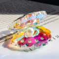 Macro view of a colorful AB crystal shell figurine with a central white pearl - AB Colorful Crystal Pearl Shell