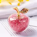 Close-up of decorative crystal apple filled with red gravel and a golden leaf stem - Gift Box / Pink