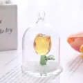 Close-up of a yellow crystal rose in a glass dome on a faceted base - Rose Ornament / Yellow