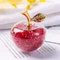 Detailed macro view of a luxury crystal apple ornament with red stones and gold leaf - Gift Box / Red