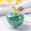 Close-up macro detail of a decorative crystal apple ornament with green gems and gold leaf - Gift Box / Green