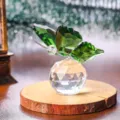 Detailed view of a green crystal butterfly perched on a faceted crystal base. - Butterfly Design / Green