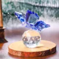 Detailed view of a blue faceted crystal butterfly on a clear glass sphere ornament - Butterfly Design / Blue