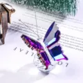 Close-up of a faceted crystal butterfly with purple gradient wings on a glass ball - Fancy Purple Butterfly