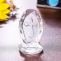 Elegant transparent crystal cross ornament with faceted egg shape and decorative base - Cross Ornament / Clear